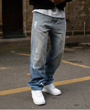 Mid Blue Baggy Distressed Jeans.